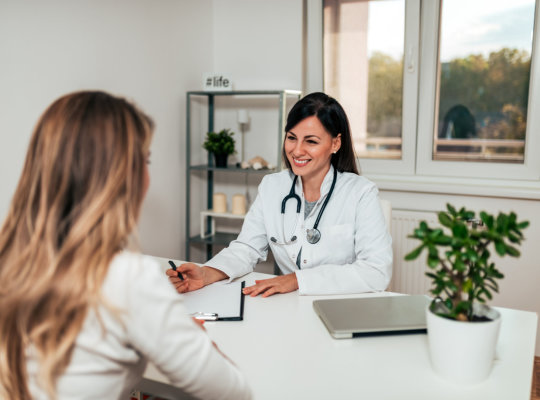 woman having conversation with female doctor