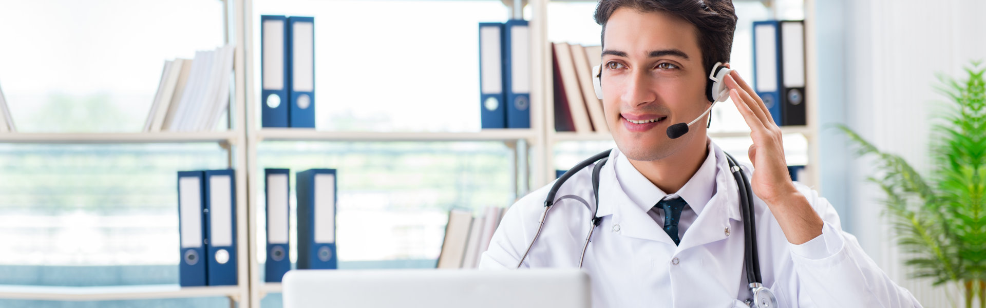 young male doctor wearing a headset