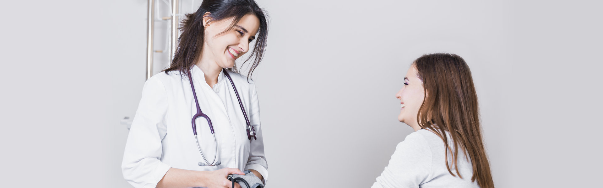 doctor checks blood pressure of the patient