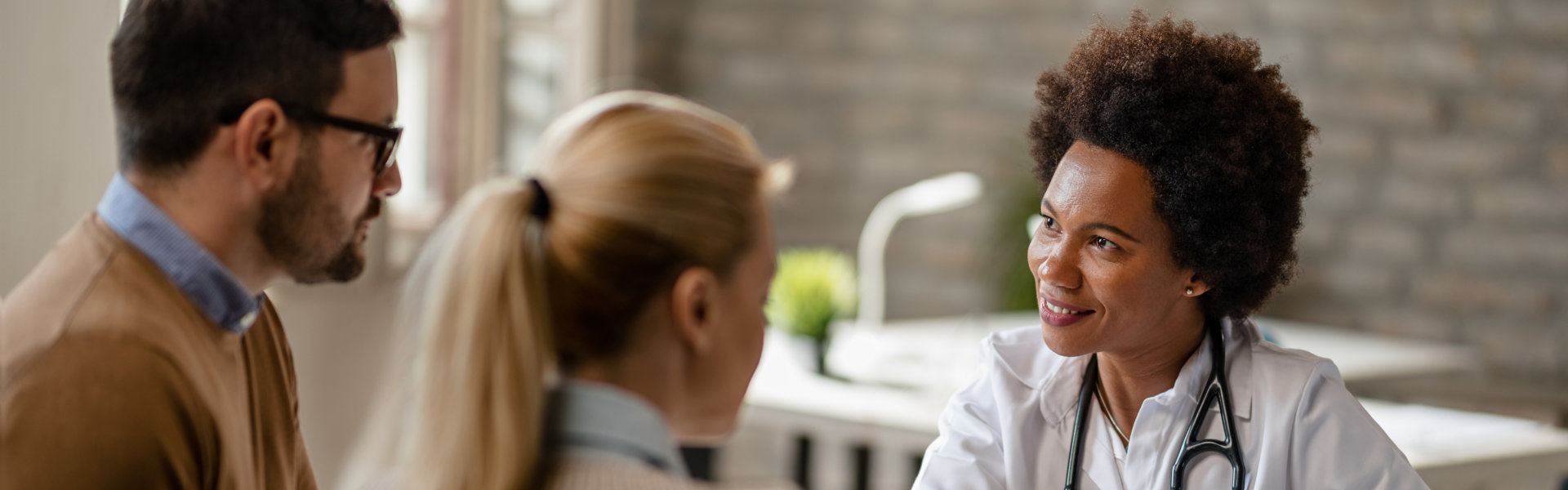 doctor talking to a young couple